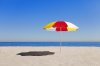 umbrella-in-sand-on-empty-beach-hybrid-images.jpg