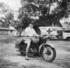 B 1942 C4603128 At AFS HQ India, Lt. C. Norman Jefferys poses on his motorcycle..jpg