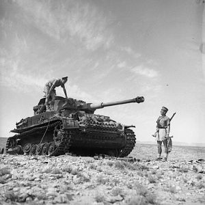 Scots Guardsmen inspect a knocked-out German PzKpfw IV tank near Medenine, 12 March 1943; IWM NA 1106