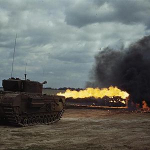 Churchill tank fitted with a Crocodile flamethrower in action, August 1944; IWM TR 2313