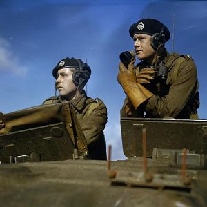 Squadron leader in the turret of a Churchill tank giving orders through a microphone; IWM TR 218