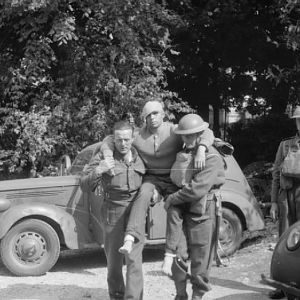 Grenadier guardsmen help a wounded German pilot after his capture, Somme, 1940; IWM F 4539