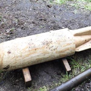 Wooden bomb by old bomb crater