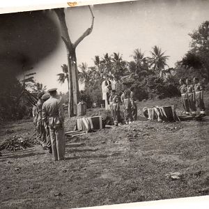 The padre reading The service over The coffins