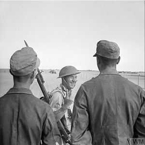 A British soldier gives a V-for-Victory sign to German prisoners captured at El Alamein, 26 October 1942