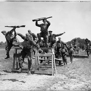 Coldstream Guards running an assault course in full kit, 20 June 1940; IWM H 1887