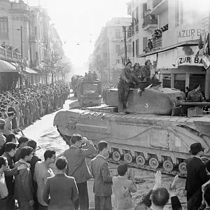 Churchill tank and other vehicles parade through Tunis, 8 May 1943; IWM NA 2880